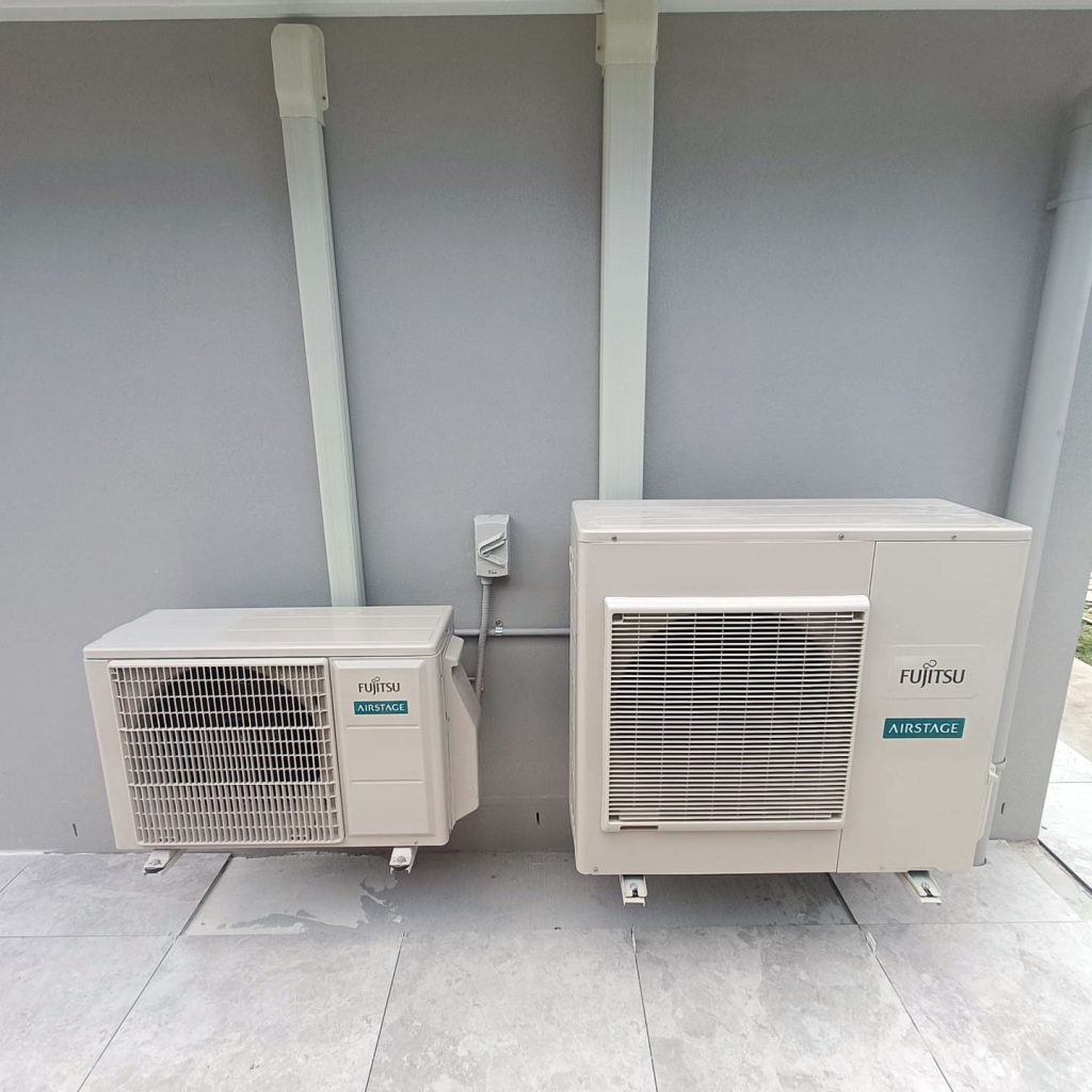 Two split-system Fujitsu air conditioning units installed outside a Gold Coast building.
