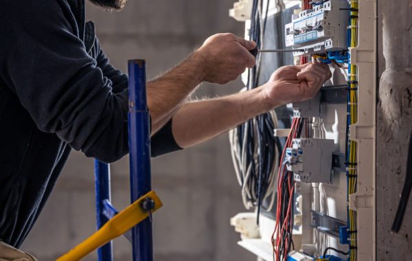 Electrician installing wiring in a new residential build.