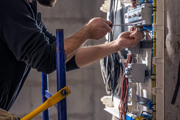 Electrician installing wiring in a new residential build.